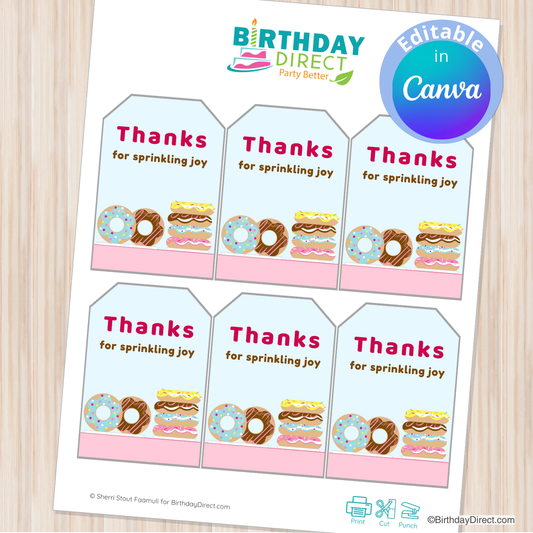 Sheet of printable 'Thanks for sprinkling joy' tags with donut designs from Birthday Direct on a wooden surface.