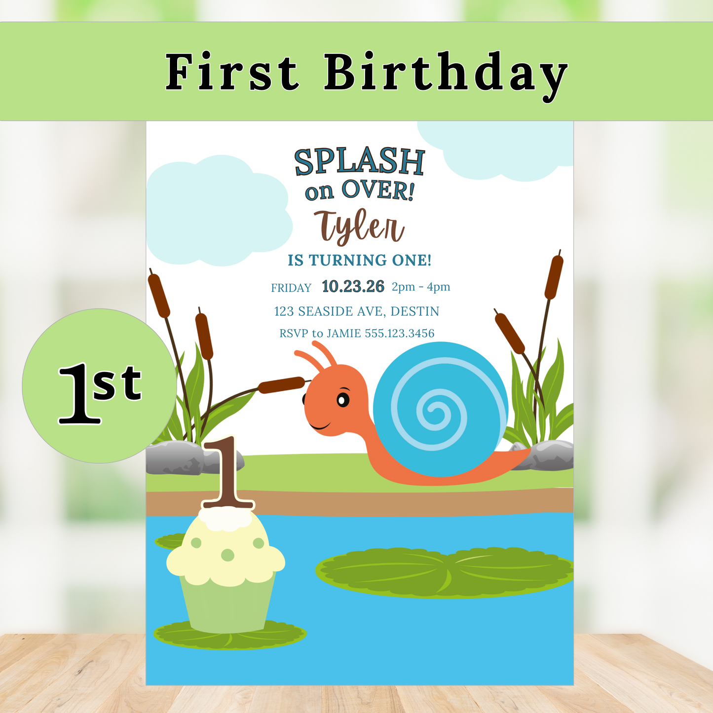 First birthday invitation with a snail and cupcake design on a wooden surface.