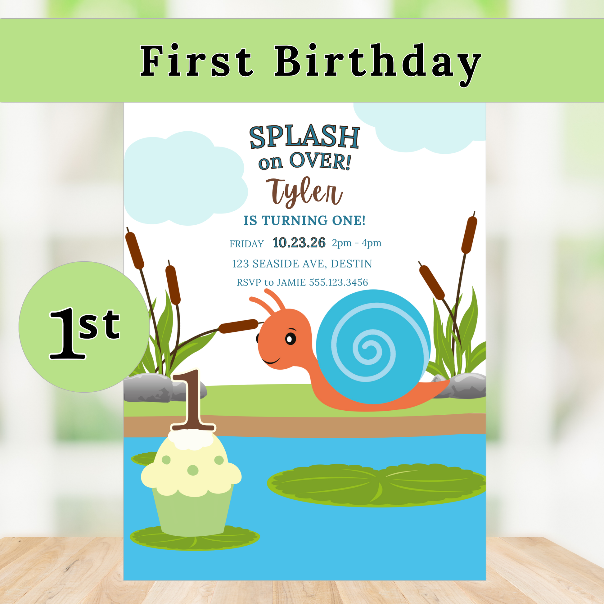 First birthday invitation with a snail and cupcake design on a wooden surface.
