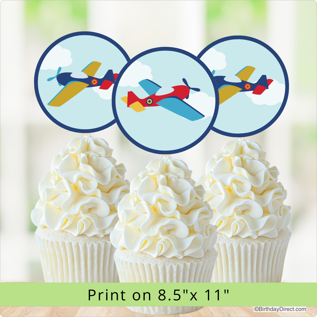 Cupcakes with airplane-themed decorations on a light background