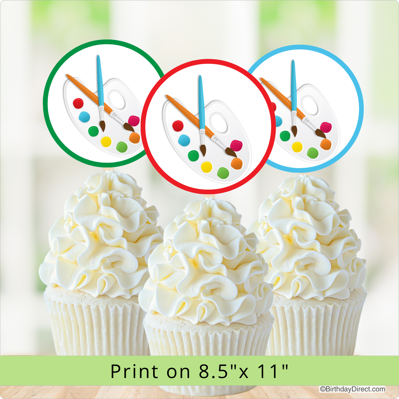 Decorative cupcake toppers with paint brushes, an artist's pallette, colorful designs on a white background