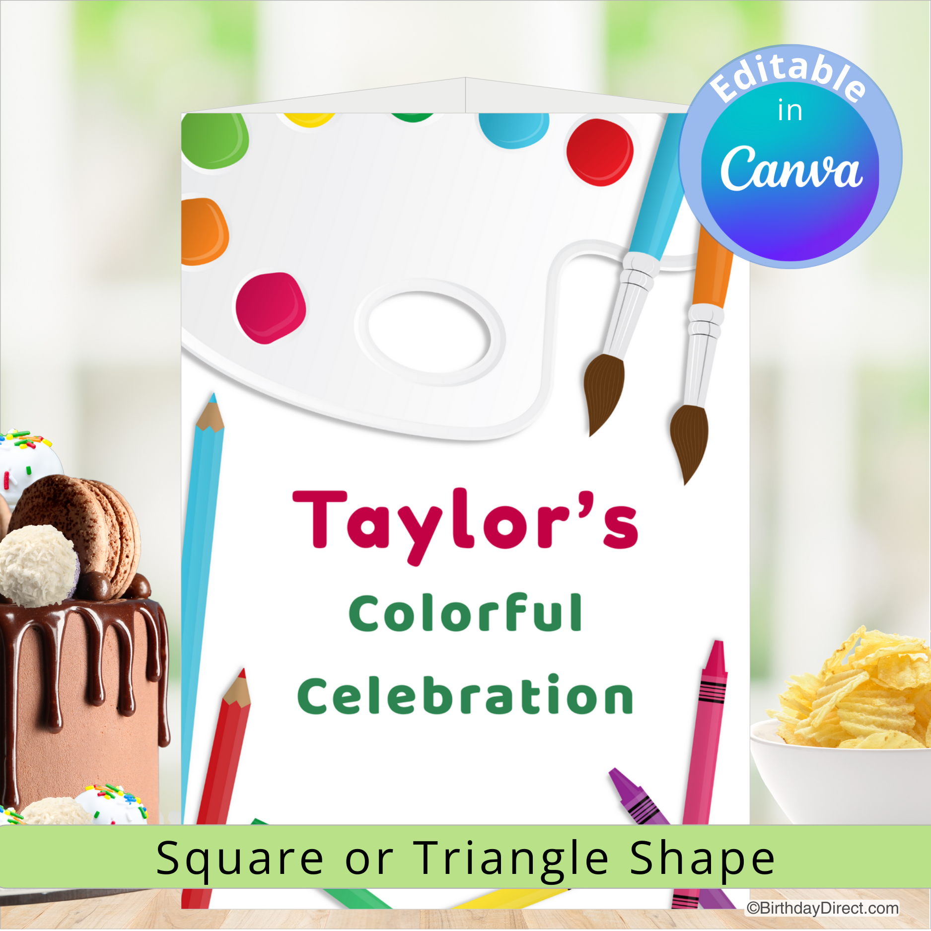 Colorful birthday centerpiece decoration celebration design with paint palette, cake, and snacks on a blurred background.