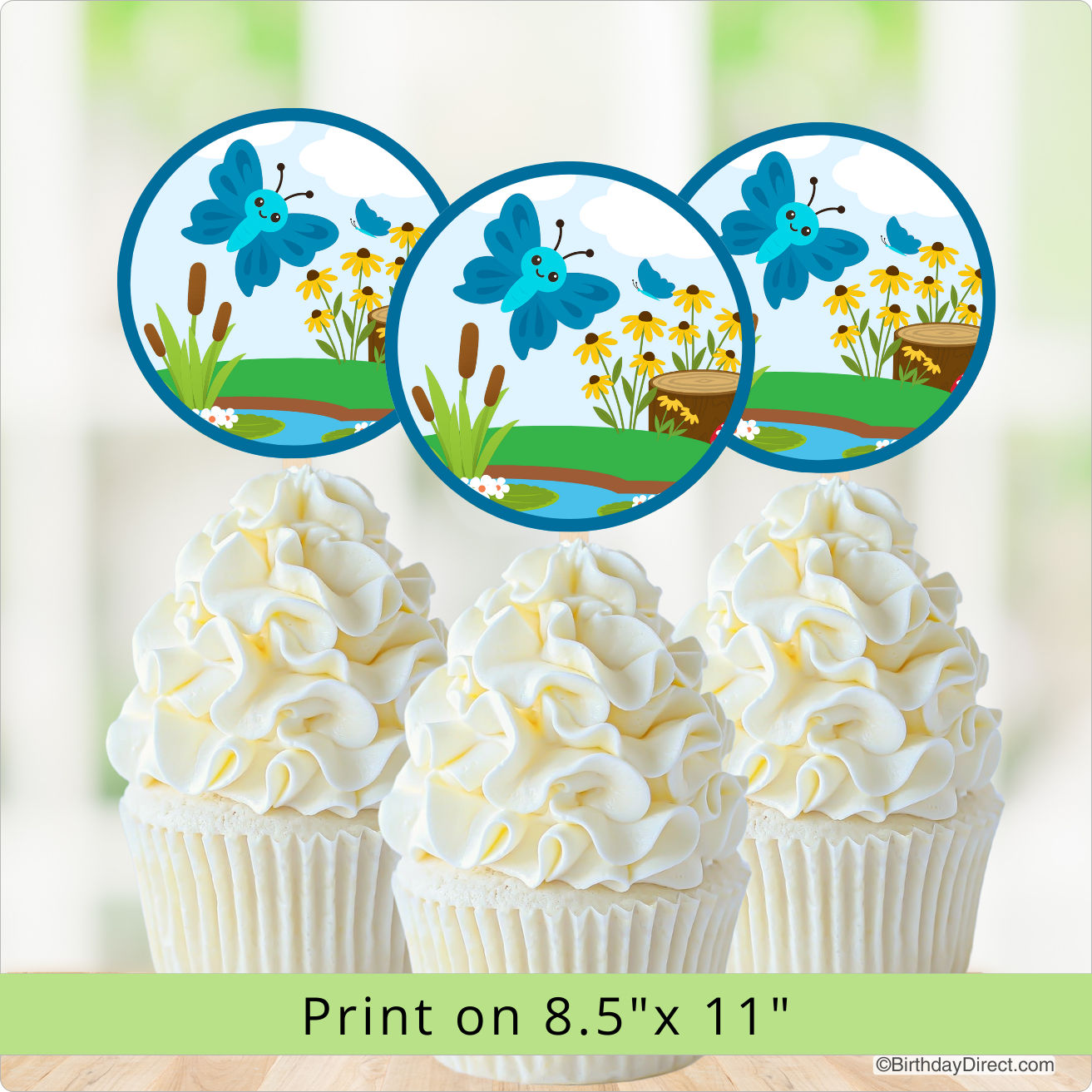 Cupcakes with white frosting and butterfly design on a blurred nature background