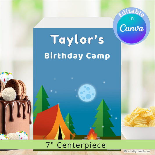 Birthday camp-themed centerpiece with a tent, trees, and moon on a blue background, featuring a cake and chips on a blurred background.