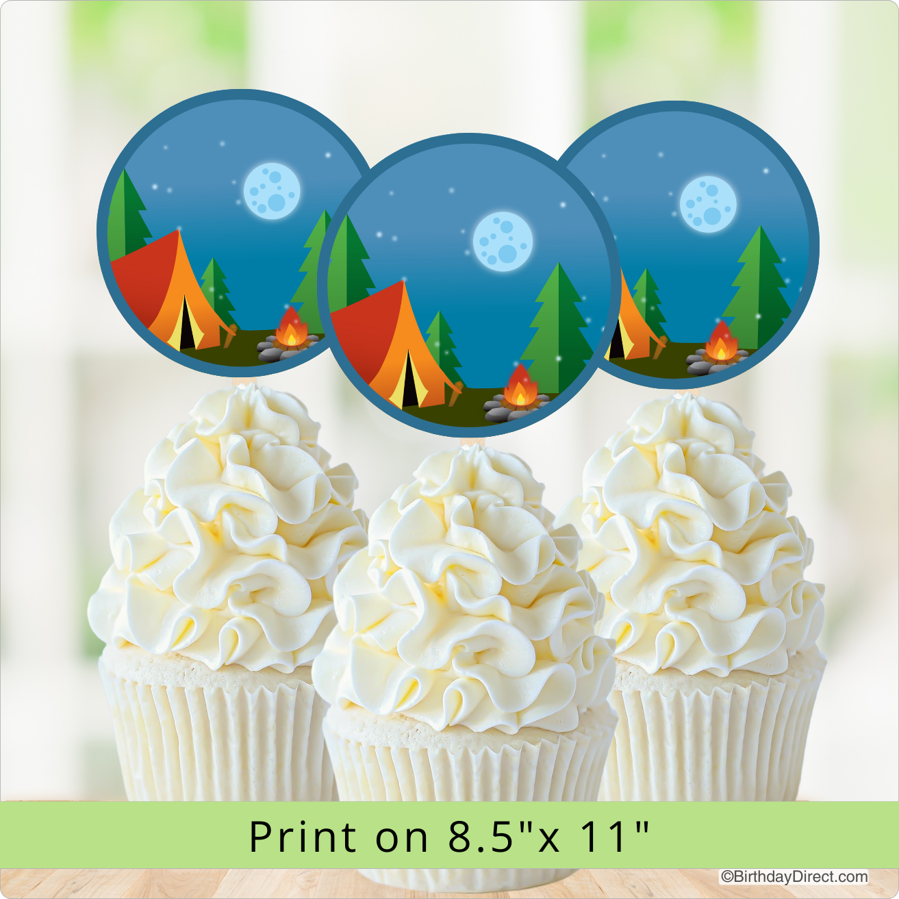 Cupcakes with white frosting and a camping-themed design on top, with a blurred background.