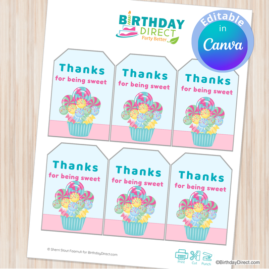 Sheet of 'Thanks for being sweet' gift tags with floral designs on a wooden surface