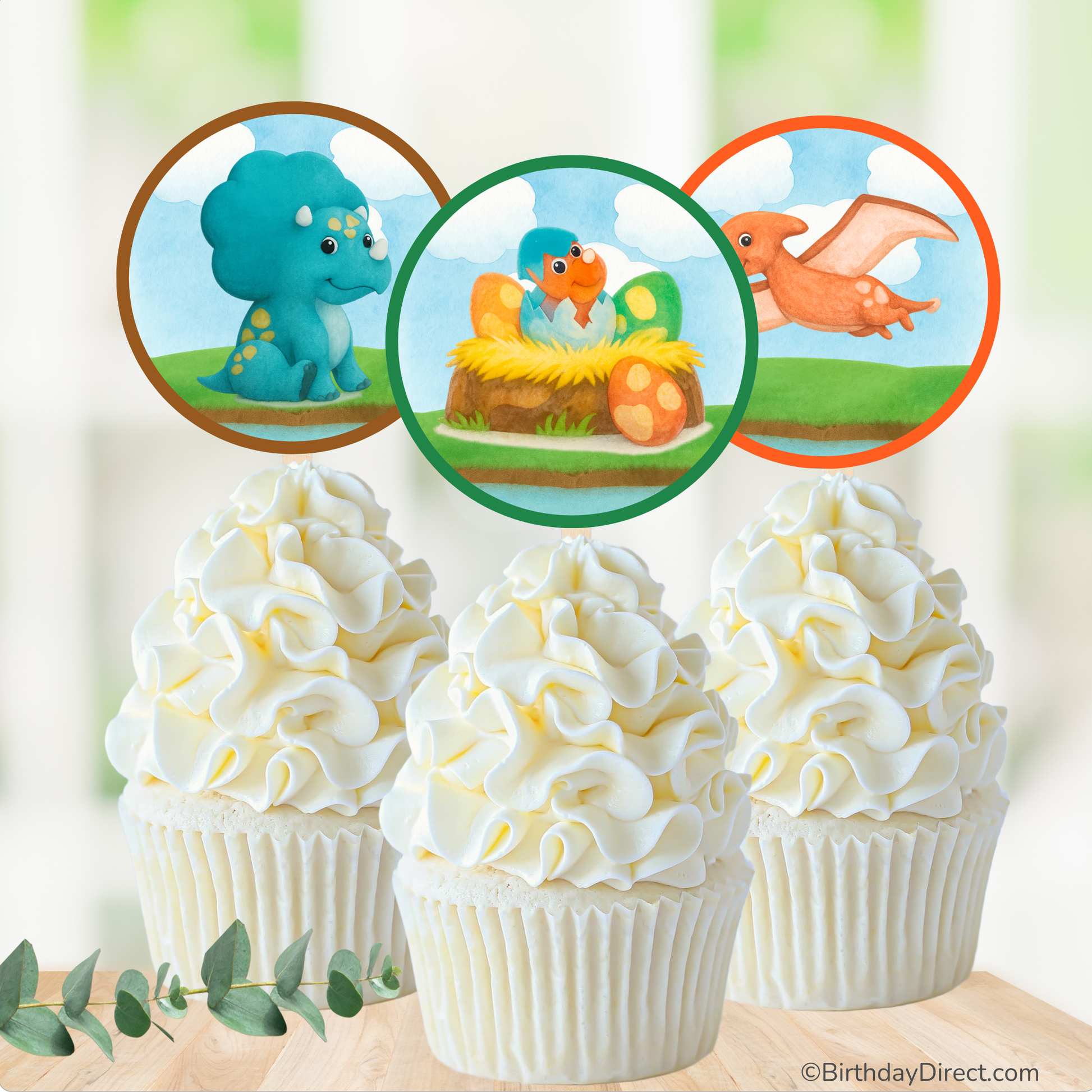 Cupcakes with dinosaur-themed toppers on a blurred natural background