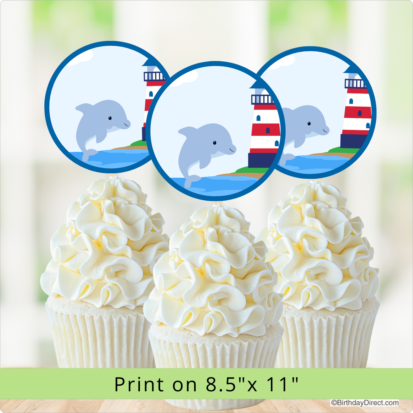 Cupcakes with white frosting and a lighthouse and dolphin design on a light background