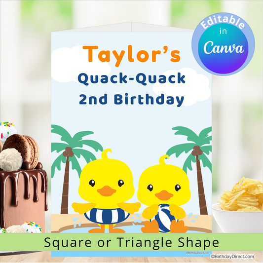 Birthday centerpiece decoration with two ducks, palm trees, and a cake on a blurred background.