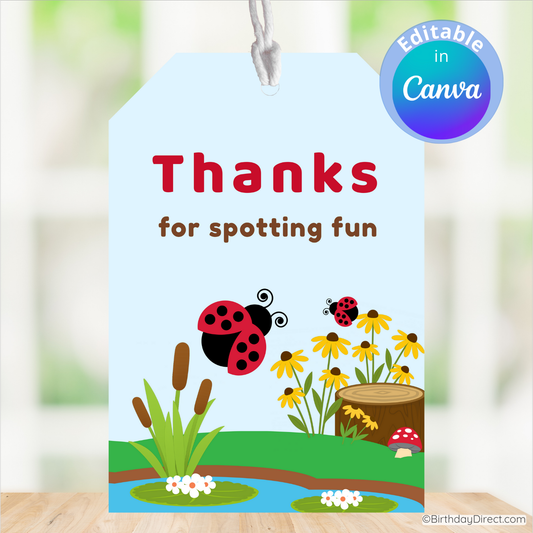 Gift tag with ladybug design and 'Thanks for spotting fun' text on a blurred nature background.