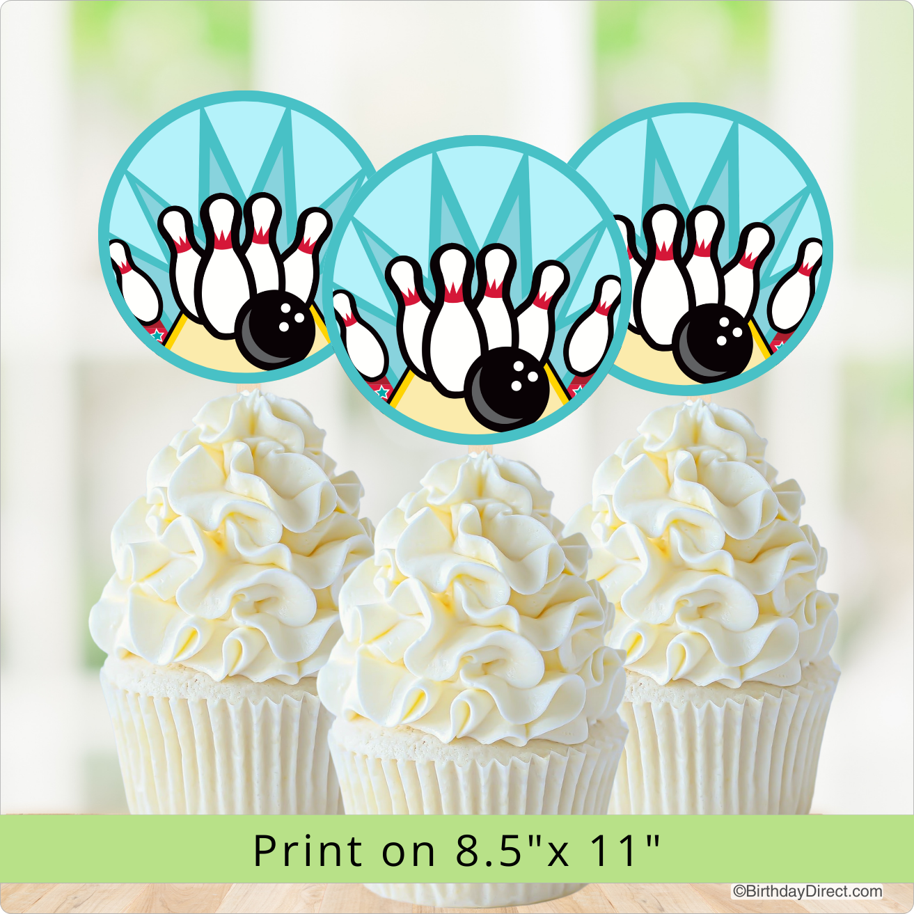 Cupcakes with white frosting and a bowling-themed design on a light green background.