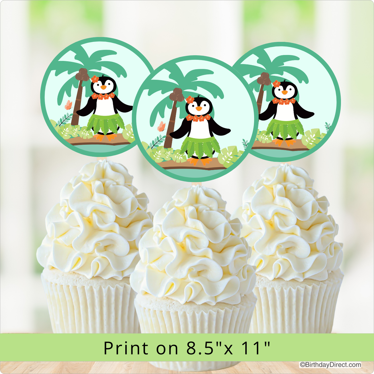 Cupcakes decorated with penguin toppers on a light background