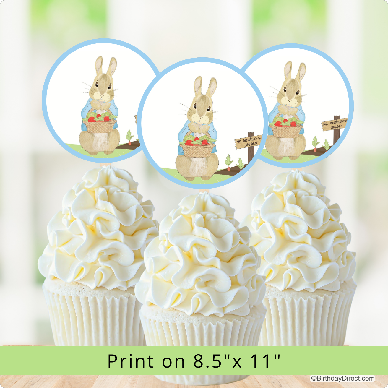 Cupcakes with white frosting and Peter Rabbit on top, with a focus on the bunnies.