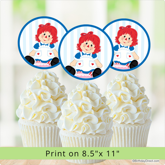 Cupcakes with white frosting and a Raggedy Ann Doll on top, with a print size note.