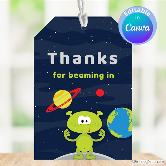 Space-themed gift tag with a green alien, planets, and text 'Thanks for beaming in' on a blue background.